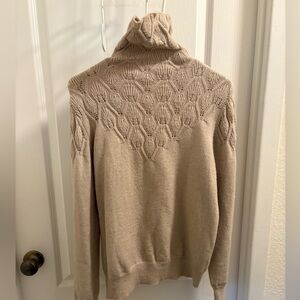 This is a long sleeve turtleneck tan sweater in size large (12).